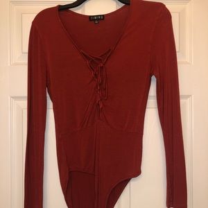 Burnt orange body suit